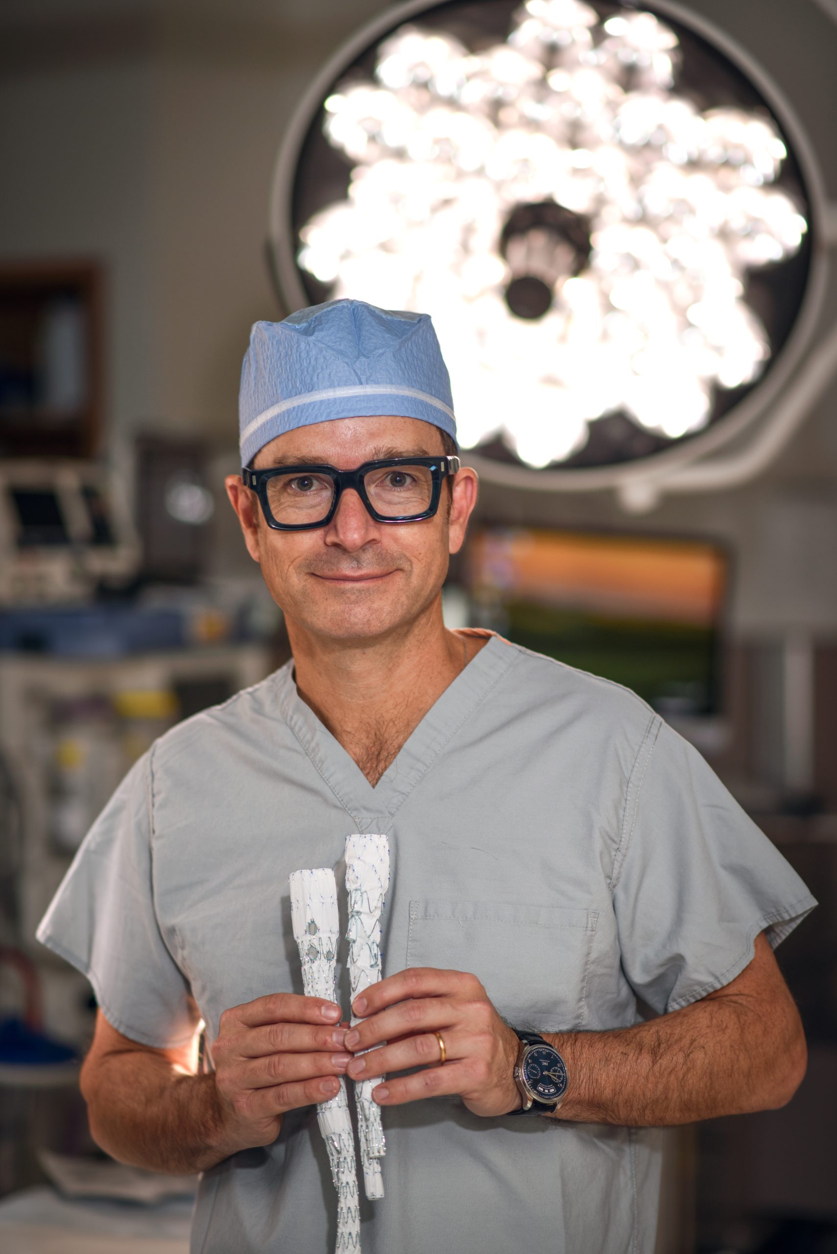 Dr. Gustavo Oderich in the operating room holding stent-graft devices